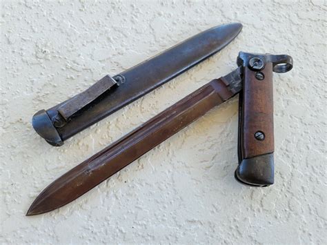 M/91 Moschetto per Cavalleria <strong>bayonet</strong>: This is a permanently attached fixed <strong>folding bayonet</strong>: its narrow T-section spike is hinged to a block at the muzzle (which also takes the front sight) and <strong>folds</strong> back under the barrel and into a slot on the lower side of the stock. . Carcano carbine folding bayonet for sale